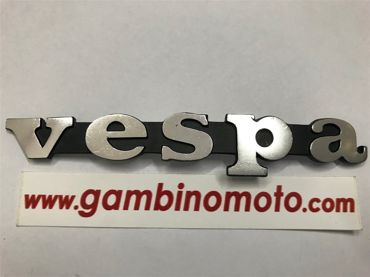 TARGHETTA SCUDO ANTERIORE PIOLI DA 58MM VESPA 50 SPECIAL R L N VESPA PX125-150-200